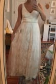 This dress is lovely! Shockingly comfortable for a wedding dress. It's lightweight and somewhat stretchy; not bulky or heavy in any way. The detail is simple but beautiful, and the silhouette is understated but elegant. It has a warm golden beige undertone that keeps it from being too stark of a white. While this wasn't my dream dress, it was a very close second. - Carolyn C.