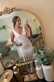 This dress is my Catholic ceremony dress for my wedding! It's so beautiful and elegant. It has a tighter fit which I like, and is a thick material. Obsessed with the low back and button details! I will need spanx for the tummy area but it would be fine without too. 10/10 you need this for your big day! - Natalie K.