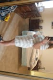 I love this dress. Its an easy to wear every day dress you can also dress up. As others have mentioned it is a little loose in the mid section, but that is actually a reason why I bought it. I am pregnant and this dress will grow with me which I love. You may need to size down in this dress so it is not so loose in the mid section. - Yvette P.
