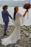 I ordered this fabulous dress for my boho elopement at June Lake, CA and it was absolutely perfect! I was looking at a similar dress off Etsy that was 10 times the cost and am so so happy I made this purchase instead. It fits great, the flower lace is flawless, sexy leg slit, the train length was exactly what I wanted, well made zipper (huge deal for me because it doesn't get stuck) and shows just the right amount of back and cleavage for my liking. Plus the hubby LOVED it too! The bell sleeves are so much fun and I received many complements from fellow lake goers. Lulus is accommodating, allowed me to order two sizes and gave me some extra time to decide which size I was most happy with. Email them if you have any questions, their customer service is amazing and they respond quickly. I'm so grateful to have this dress on my special day. - Amber D.
