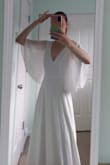 This dress is perfect for a winter or fall bride looking for a very simple, clean silhouette at an AMAZING price. I ordered the size XS for this dress and it fit perfectly (train is a little long to be expected). I ended up returning this dress because I wanted something with a bit more embellishment and lace detail (no beading or lace detail on this dress, just chiffon). The lining is a bit heavier and a cheaper polyester material, but it covers all undergarments and can't be seen under the top chiffon layer. There is no padding or boning, but you could definitely wear this dress with a bra (watch out for the deep plunge back neckline) or sew in your own cups. - Katrina N.