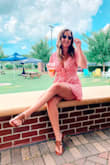 I bought this because it looked flattering on everyone I saw photos of and it did not disappoint! This romper was so flattering and comfortable, and I got so many compliments. The fabric is super soft and breathable -- perfect for a hot humid day. A couple of things to note: I was able to wear a bra from VS that had a skinny center strap between the cups. I just tied the front tie onto my bra and you couldn't even tell I was wearing it! Also worn it without a bra and it's just as flattering. It's also pretty short, which wouldn't be an issue but the shorts are so flowy that with even the slightest movement, you could see everything underneath -- I just wore a little pair of boy shorts underneath and that solved the issue! - Katie M.