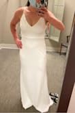 The fabric is thicker than I thought. I was a little nervous to order such a form fitting dress but the material isn't clingy. It is soft and stretchy and very forgiving. The straps are adjustable which is helpful but I am getting them altered so it looks more expensive. The length is extra long!  I'm 5'8" and it was pooling at the feet. - Megan P.