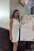 I wore this to my bridal shower and received so many compliments. It says do not iron, so I used a garment steamer and the wrinkles went away beautifully. It's very flattering because it's fitted and shows shape without being skin tight. Highly recommend for any brides out there looking for a white dress for pre-wedding festivities. - Jenny C.