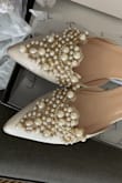 These shoes are really pretty! And would be perfect for your wedding day! But, they fit really weird and a bit uncomfortable. Very narrow on the toe area. I wish there was a cuff around the ankle to stop the shoes from clacking up and down when you walk. - Sarah D.