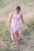 This dress was perfect for my friends' last minute elopement on the coast. The length didn't need any alterations for my 5'6" height, and because the skirt has the wrap slit, I was able to easily hike over sand dunes and climb up a cliffside for the photo session. The bodice/back was a little tight. Typically I wear a medium top and large pants, so I may have benefitted more from a size large around the ribs for this dress. That being said, I was hiking and adventuring in the dress, so my body needed more room and flexibility than the average wearer for your standard wedding. As for undergarments, I would recommend nude colors, as the light pink shows what's underneath. Personally, I used boob tape to secure and obscure my nipples due to the amount of physical activity I was doing in the dress and it worked very well. - Alexandra M.