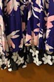 I originally bought the blueish-purple floral wrap dress for a wedding 2 years ago, IT FIT PERFECTLY! I just ordered the black and white floral wrap for my engagement photos. They list the dresses together so I assumed they would be the same. I ordered a medium in the blueish/purple so I ordered that in the black/white. It came and the medium was HUGE. The material was not the same. The black/white dress has a liner which makes it much more fabric to wrap around. It looked so big and baggy, not at all flattering. Oh and not to mention I held both colored dresses up to one another, the black/white one was 4-5 inches longer than the blue/purple dress. I never have issues with length but couldn't believe how long it was. I am set on the dress so I returned the medium and ordered a small. The fit is much better however, the wrap is not as long around the waist. The slit hits more to the middle than off to the side. - Jacqueline B.