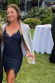 This dress might be my favorite from Lulus yet! I wore this to an end of August wedding and it was just the right amount of fun and classy with the high/low hem and lace details. The straps are adjustable and criss cross  so it was nice because there really isn't a way to wear a bra without it showing. If you are large chested this might be an issue. There is not a lot of stretch in the material. I usually wear a small, got a small and it fit "just right". If you are in between sizes I would size up. Overall beautiful dress and got so many compliments! - Annette S.