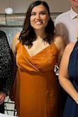 This dress was out of my comfort zone and I'm so glad my coworkers talked me into it. I wore this for a gala and it was beautiful. The boob area was a little large, but the adjustable straps helped. My mom also stitched the overlap in the boob area so it wouldn't fall open. I wore the dress with a two and a half inch block heel. She also had to take off a couple of inches of length otherwise it would have been way too long (of course I'd much rather have this and trim it to my length preference). I didn't have any issues with it around my waist or falling off my hips. I hold my weight in my stomach/butt/thighs and was nervous about how it'd flow, but it was very flattering.
The dress overall was comfortable and the material was great (does crease a little after sitting, but that's to be expected). I got so many compliments on the color. Overall I'm really happy I got the dress and I will definitely wear it again! - Christina M.