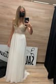 This dress is perfection! I had a small wedding and couldn't afford/didn't have the time to have an expensive, tailored dress. But this was like tailored! I did have to have 6 centimeters (about 2.54 inches) taken from the bottom, I suppose it's better to have it too long than too short in the beginning. Everyone was raving about the dress and asking me where I got it and now, after the wedding, I don't have the heart to put it away and am just admiring it hanging while working from home. The first photo is from before I got it hemmed, the second one from the wedding day. - Helga S.