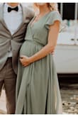 This dress was pretty and comfortable. I usually wear a size medium (when not pregnant) which is what I ordered because other reviews said the dress runs large so I felt confident this would fit well with my baby bump.  I was surprised with how large it still was. I wish I would have ordered a size down.  Even with my bump, it was large and I needed to use double sided dress tape to help it fit okay for the wedding. Otherwise, the dress was great, but I would recommend considering ordering at least 1 size down. - Melinda S.