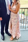 Wore this to a recent wedding and received so many compliments! I did have to get the length hemmed a few inches as it did drag on the ground initially (but I am short and didn't wear huge heels). The straps in the back are adjustable which was great and I wore sticky cups but I don't think a bra was needed at all! I also did pin a section of the slit as it had the tendency to open up wayyyy to high (literally hello underwear). Will definitely wear this dress again and again! - Annalie M.