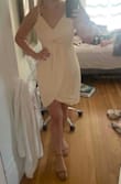 At first I was nervous it would be too white/light to wear to a wedding but it's definitely more BEIGE/YELLOW! I was in-between Small vs Medium but VERY happy I went with the Medium. Once on, you can tell the dress is meant to have a little breathing room & sway, which made it extra flattering no matter the body type. The length was perfect for a summer outing and the front layering was comfortable and sat at the ideal spot on my chest! - Jennifer H.