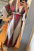 This dress is so flattering and amazing! I read the reviews, and they all said to size down. I usually go for a small/medium on dresses (I'm larger chested), and I measured myself, and I was on the cusp of a medium but ultimately ordered the small, and so happy I did. This dress fits perfectly, a little longer, but I can always wear heels. The v-neck is perfect and so flattering! I highly recommend this dress and think it needs to be in everyone's closet. I got so many compliments, and the zippered back just made the fit even more perfect! You will need to iron this dress but irons super easily! - Catlin B.