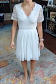 I was looking for a dress to wear to my rehearsal dinner in Texas and while the heat is still on, the sleeves were too much for me. Otherwise, it's a very conservative cut and fit. I am a small in most other Lulus dresses, but I sized down for this and it worked! The scalloped neckline is a fun detail as well as the scalloped sleeves! The sleeves may have bothered me just because of how thick the material is. - Randi N.
