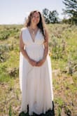 I loved the comfortable feel of the material. I ended up choosing this dress over a more expensive dress I bought at David's Bridal. It was very comfortable and worked perfectly for the active wedding that I had. I did add a slit on one side so I could have 2 and ride my horse. I could not have been happier with the fit, the comfort, and the day! I didn't have any great photos of the back of the dress. - Noelle G.