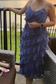 I am usually an M but since this one is flowy the S fit perfect . It has a zipper on the side so you can fit in it . And I loved the ruffles they make you look slimmer. - Janice M.