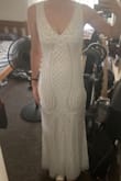 This is a beautiful dress. I got it on super sale and am keeping it as a possible wedding dress. The quality is amazing for the price, but it's also only cost-effective if you don't need any alterations because the beading is intricate. It has a little stretch though so it's good for sizing down. It's a bit tight on my thighs right where the mermaid skirt flares, but otherwise it fits well and is fairly flattering. It's the perfect length for me with a short heel - like 1.5 or 2 inches. It is slightly see through so you need good nude underwear or a white slip. I might add a tulle overskirt for the ceremony if I end up wearing it but overall I'm thrilled. - Erica P.
