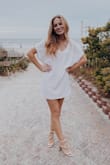 The style of the dress is very loose and oversized. If you want something to highlight your waist or your bust, I would not go with this. It highlights the legs with it being on the shorter side. I am only 5'3" so if you are taller than me, you might find this pretty short. It is like a glam t-shirt dress. Which is exactly what I wanted for my beach bachelorette weekend. I really like how you can make it more or less casual depending on your event. - Loey H.