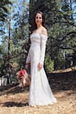 I absolutely LOVE this dress. It was perfect for my wedding day. I had a dream of a lace long sleeve dress and was disappointed that most were too modest, covering the entire chest area. This was PERFECT in showing a bit of skin but still being classy and beautiful. I typically wear a size S or XS, but the XS was too baggy on me. To my surprise, the XXS fit like a glove and showed off all the right curves. I did have to get it hemmed but that's only because I didn't wear heels. All in all, this was my dream dress and I highly recommend. - Gabrielle D.