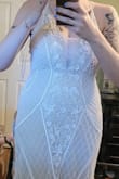 This dress fits amazingly. It isn't white at all except the beading, but that is exactly what I was looking for as it is my second marriage and I'm having a sort of non traditional wedding.  I also had a baby 3 months ago. While I have a tiny "pouch" this dress hides it pretty well. I bought it pre-baby and knew it felt loose enough around the waist that it'd be fine either way. The tight area is the bust...I cant step into it, it has to go overhead. But I can zip it myself so that is a bonus! I had to get an undergarment that had a built in bra with invisible straps to make it work in my chest...the dress didn't provide lift even with the cups. The length is beautiful.... touches the ground just enough with some small wedges. - Jaszmin T.