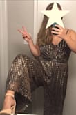 I love this jumpsuit! The legs/hips are super stretchy, and the lining is as comfortable as pajamas- I expected the metallic fabric to be scratchy, but it wasn't at all! A few (~5) of the gold sparkles came off when I was wearing it, but not excessively, and they stayed on well when I gently hand-washed in warm water. This outfit was a scene-stealer at a recent wedding reception, and it was incredibly comfortable for dancing, sitting, and moving around. The straps are easily adjusted for a perfect fit, and the pants brush the floor at my height (5'5") without heels and are a great length with 2.5/3" heels. - Shannon R.