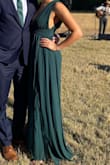 I wore this dress to a formal wedding and absolutely loved it! The v in the bust goes prettttttty low so chicken cutlets or another bra contraption are needed. I think this dress would be perfect for someone with a bigger bust. My bust is a little smaller and the straps felt just a touch too long. I only needed a short heel for this not to be scraping the ground. Overall though, great dress - Olivia P.