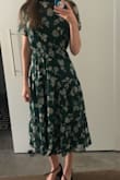 I ordered this dress in a S and XS and the XS ended up fitting better because it was cinched in a bit more around the waist. I've already worn it to two fall weddings and it fits great! Super comfortable and really flattering. - Erica E.