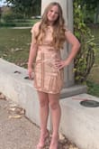 This dress is true to size. It has a little bit of a give to it except around the legs. Just the right amount of shimmer. - Kimberly E.
