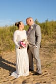 I loved everything about this dress!  The material is very comfortable and lightweight. It was perfect for my September beach wedding. It does have a nude slip underneath that really made the white lace pop.  It looks beautiful in pictures. I especially loved the train on this dress and I added a belt for a little more sparkle. I did have it hemmed up since I was in flats. The process was very simple since there is a seam at the bottom. I highly recommend this dress to any bride! - Michelle M.