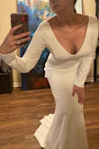 I'm delighted with this dress. My only concern is that the sleeves aren't lined and so you can see through them slightly unlike the rest of the dress. I may have a skilled seamstress remedy that problem for me as I'm having vintage white fox fur cuffs added, as well. It really checked all the boxes of exactly what I was looking for after a scouring retail options at literally every price point with a stylist friend. We did not discriminate and we were simply aiming for the perfect lines and to achieve the aesthetic goals we had in mind for my winter wedding, even if it meant we had to have one custom made. This dress not only allows me to not have to have a dress made, I don't even want to make any changes other than adding fur cuffs and lining the sleeves! It's beautiful, a total steal of a price point and surprisingly well constructed! I'm delighted. Photo taken of dress after trying it on right out of the box in my front hall. - Tianna H.