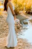 I originally ordered a small which did fit well but returned because I wanted the dress to be a little tighter/form-fitting. I LOVED the way the XS fit. The material is really nice, thicker, and has stretch to it. I didn't need to tailor for length either, the dress was the perfect length for me with heels on. - Heather S.