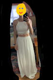 I ordered this in a small and extra small. The extra small top fit me slightly better than the small but with the small pulled tight it fits well. I could fit into the small and extra small skirt but the extra small was a little tight. I ended up keeping the small and getting it hemmed. While I was there, the seamstress suggested sewing in a little bra padding. It looks pretty good and now I don't have to find a strapless bra for it. Highly recommend. These photos are from before I took it to the seamstress though. (Please ignore messy background of photo) - Jackie F.