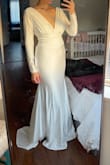 Pros: 
- It fits perfectly and it hugs all the right areas (note that the dress will accentuate areas of the body. I'm 10 months postpartum and have a bit of a belly. I'm also wearing shapewear under the dress to help smooth everything out)
- I like that it's not too long that I'm going to trip and die while walking down the aisle, and love the back of the dress and how has a bit of a train. 
- I have a half sleeve tattoo, and the sleeves are not too thin that it sees through in daylight and that made me happy as I am looking to cover it up for my wedding. 
Cons:
- The quality could do a little better, but it's dress under $200 so I'm not asking too much of it. I didn't like that I can see the built in bra padding, but it's not super obvious so I'm fine with it. 

Overall it's a great dress that I am happy to wear on my big day! - Donya D.