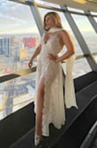 I would've worn this to my own wedding if I had seen it before. So, I ended up wearing it on my wedding anniversary in Vegas. With no exaggeration all eyes were on me when I walked in it in the lobby of one of the busiest and most luxurious hotels in Vegas. Buy it! 

It comes with a nude bodysuit which makes is super sexy without having to reveal much. It was a bit long for my height but I had it hemmed and used the extra fabric as a scarf to compliment the look. - Nataly R.