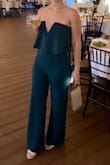 This jumpsuit is beautiful. The color (green), fabric, and more formal look of a jumpsuit. I had to tailor the length because it was superrr long. Probably fits perfectly on a 5'9" person. I also had to pick up the midsection. The tailoring is worth every penny. Buy now! - Kayla S.