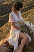 I bought this dress for my small wedding. It was exactly what I was looking for and I got so many complements on it! The only comment I would have is that for someone with a larger chest, it was quite revealing and it didn't exactly stay put so I kept having to adjust it during photos so the world didn't see my bra. Luckily my flowers covered it up most of the time. I probably could have gotten it tailored or used a pin or something to hold it in place better. - Alex R.