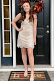 Comfortable and looks different in different lights. Not skin tight but fitted. V neck has a button close if you are more busty. Out of all the dresses we ordered this one was her least favorite, but when she tried it on she loved it. Very unique dress. - Amanda S.
