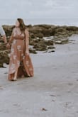 I originally got a L and had to exchange it for an XL, because it wouldn't wrap correctly. This was definitely a better fit, although the straps were a little bit big. I wore it to our engagement photos and it photographs beautifully! I did have to use a little fashion tape to keep the top from being too revealing and for the fabric not to flip outward. It's definitely too long but for the photos I didn't mind. My cat ate one of the straps to tie it so I had to tie it in the back. - Rebeca M.