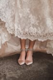 These shoes were perfect for my wedding. The champaign color is a little a little on the pink side as opposed to ivory which I preferred. They survived a full day of walking around and dancing. the heel is low enough to be comfortable for all day wear but still formal. The strip of rhinestones almost came completely off (they are all connected together as a strip, and the strip is held onto the strap of the shoe by some thread?). I can partially blame my rigorous dancing on the breaking though it could have had a more robust hold. I plan on getting them repaired and wearing them again :) - Sabrina B.