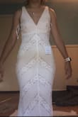 This is a very beautiful dress. good quality. the underneath party is pinkish. I thought the top was kinda big but might just be due to me having a very small chest. None the less would be easy to alter and is a great dress. - Sara R.