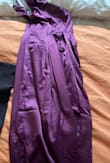 I got the purple dress which oddly looks brown in artificial light. The photos attached are taken of the same dress with the same phone camera in the same room in the evening and in the morning.

I am normally a size S in summer dresses but here I fit in an M. It's very tight around the ribs and bust so you must be lean to fit in this dress. 

I like the style, it's very elegant and I plan to wear it for a special birthday dinner.

However, I will never order from Lulus again because I am based in Europe and I had to pay a lot of import tax as well as the return for the smaller size myself. So I basically paid double for the dress, not including the original delivery price, which was steep. - Elena U.