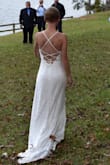 This dress is amazing!!! I received tons of compliments on how well the dress looked on me. The material is incredibly soft and very comfy. I ordered XS and S, and I kept the XS. I have very small breasts, so I was worried about the top being too loose, but I wore a stick-on bra with it and tightened the back strings, and it fit great. The dress was a bit loose around my waist, so I had it taken in a little bit, and it fit perfectly after that. However, it would have still fit if I hadn't had it altered. I'm 5'4", and I wore flats, so I had 4.5" taken off the length of the dress in the front, but I left the train the original length. My wedding was outdoors, so I walked on concrete as well as grass/leaves. The dress kept catching on the concrete and the leaves, so after the ceremony, I had to hold the train up so that it wouldn't catch on everything. My only suggestion for this dress is to add an attachment so that you can hook the train to the back of the dress when you don't want it trailing behind you. - Anna P.