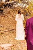 I love this dress! I knew as soon as I saw it listed, it was the one! I ordered a L and XL and the L fit perfectly! It hugged every curve just right and I felt really beautiful on my wedding day! It is a tad too long. I didn't make alterations and I kept stepping on it while walking, but I made it work. What I love most about this dress is how modest it is in the front bust area, but open back to show off my tattoo! - Briana W.