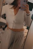 This cute little too really lives up to its title: ICONIC. Sometimes you never know what you're getting when you order a white top online, but the material was nice and thick, soft, and not see through! Very happy with my purchase! Sometimes there's a little gap between the buttons, but not that noticeable. Love, love, love! - Paige W.