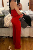This jumpsuit is an amazing addition to the wardrobe! The material is incredibly stretchy, making it fit like a glove all over. Extremely flattering on the butt, hips, legs, etc. I have a very small chest, but think it still looks good on the top. The V in front is pretty deep, so wearing a bra is hard with this, even a plunge front, but not impossible. I am 5'5 and even with 3" heels on I will likely need to have it hemmed an inch or two. I also tried on the size Small as jumpsuits can fit too tight on my torso sometimes, but found it to fit exactly the same way as an XS only more fabric up top and in the crotch. So if you're taller than 5'5 or have a super long torso, going up to S might be better for you if you have similar measurements to me. - Stephanie S.