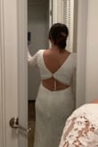 I love the dress! It's so comfortable and beautiful!!! It fits well in my arms but is a little bit big in my waist but I just need to fix it. I wouldn't change the size. It's perfect and the back part is beautiful! I'm so so so happy. I bought my wedding dress for the courthouse here in March and now for the church. The price was great also! - Agostina D.