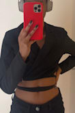I was initially worried where it would fall because I have a short torso and narrow shoulders but it looks really cute. It falls about an inch and a half above my belly button. The shoulders don't look oversize and I really like that there's a little bit of padding in them. Depending on how comfortable you are you might not want to wear a bra underneath because if you lift your arms up you can see it. The sleeves are also the perfect length! - Elise R.