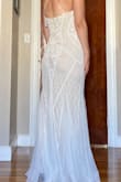 Very pretty dress. Nice details and very flowy at the bottom. Wasn't the color or as fitted as I wanted for a wedding dress. - Lydia C.
