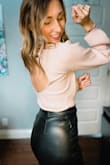I really like this turtleneck bodysuit as it tucks perfectly in so many bottoms (gotta love wearing a long sleeve that doesn't budge while tucking it). There are lots of sticky bras that you can wear or bra hacks that you can do in order to feel comfortable with the open back - this works for me as I'm a 34B. - Erin T.